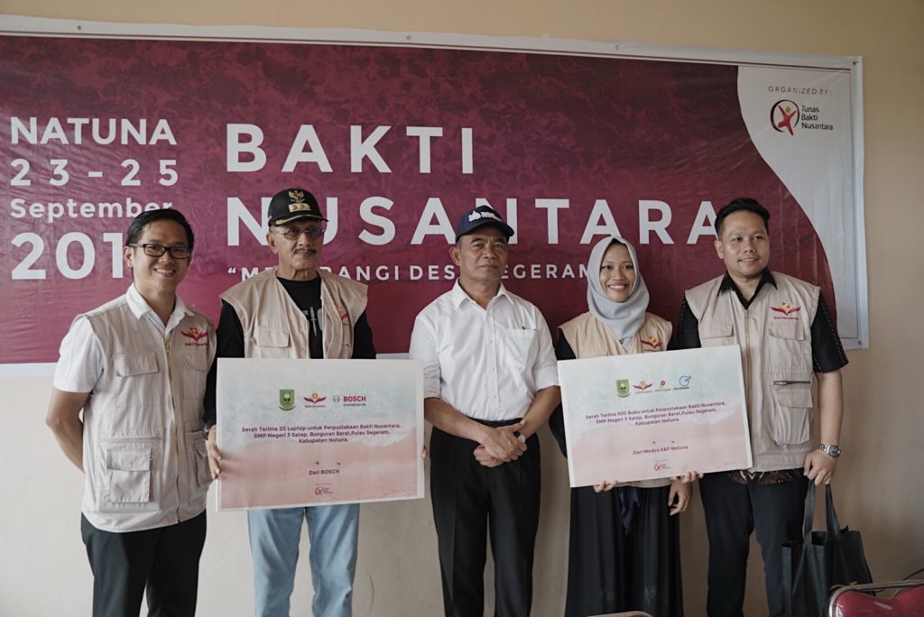 Direktur Yayasan Tunas Bakti Nusantara (kiri, berkaca mata, memakai rompi) Menyerahkan Sumbangan Laptop serta Buku kepada Mendikbud (memakai topi) untuk SMP N 3 Satap Bunguran Barat